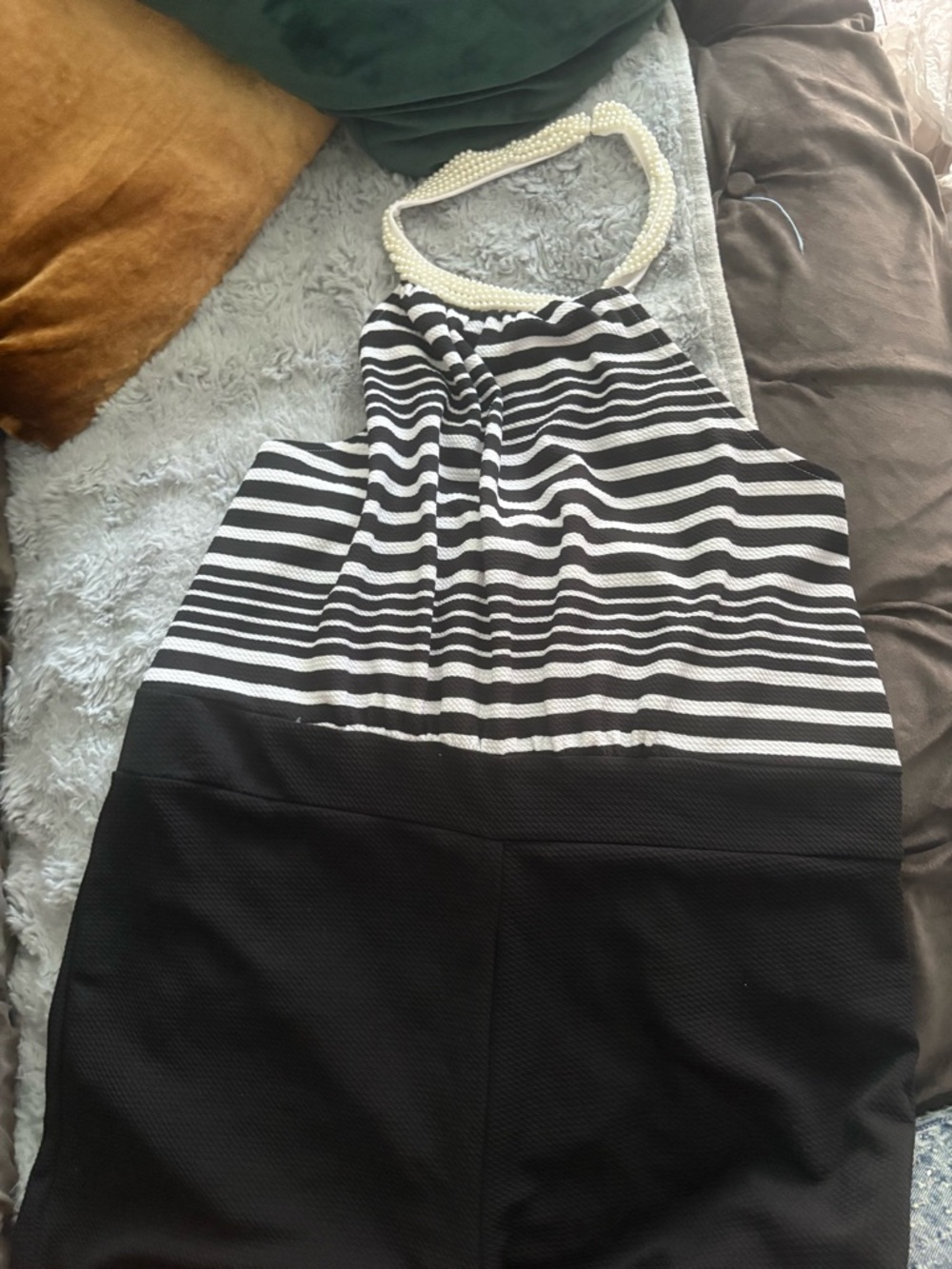 Black and white striped halter shorts jumper with pearl neckline closure.
